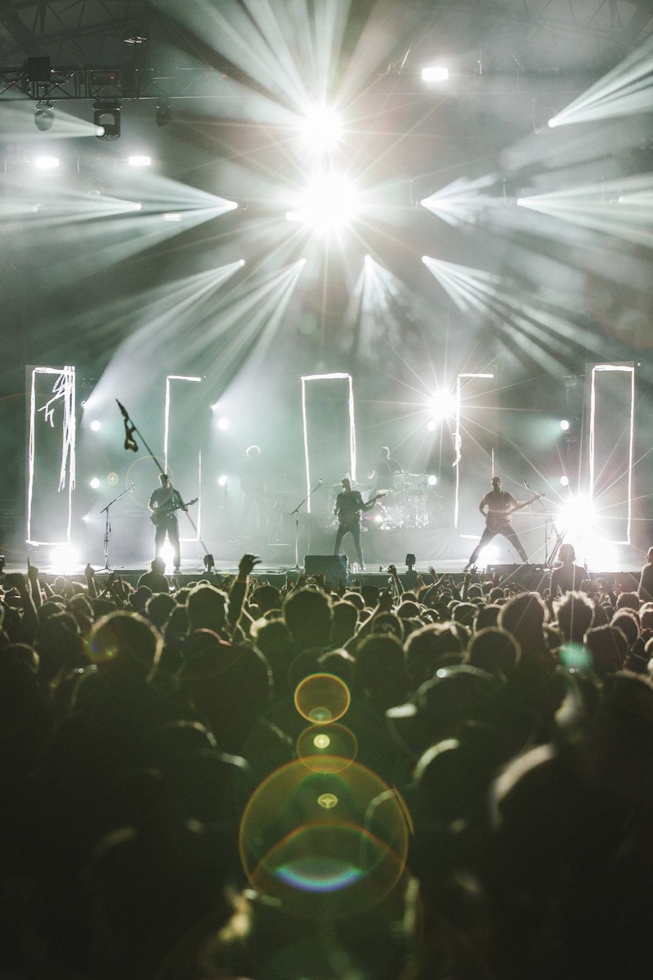 Live band on stage under full beam lighting